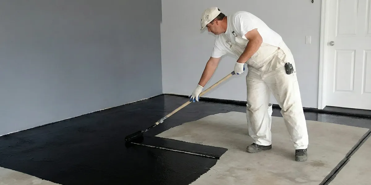 basement waterproofing professional applying waterproof coating to protect a basement floor in Cape Coral, FL