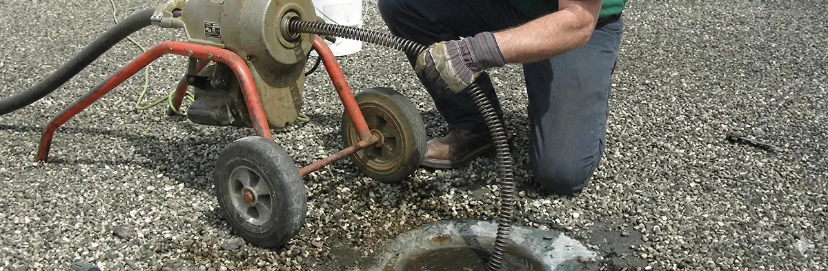 sewer rodding technician actively removing blockages from a sewer line in Cape Coral, FL